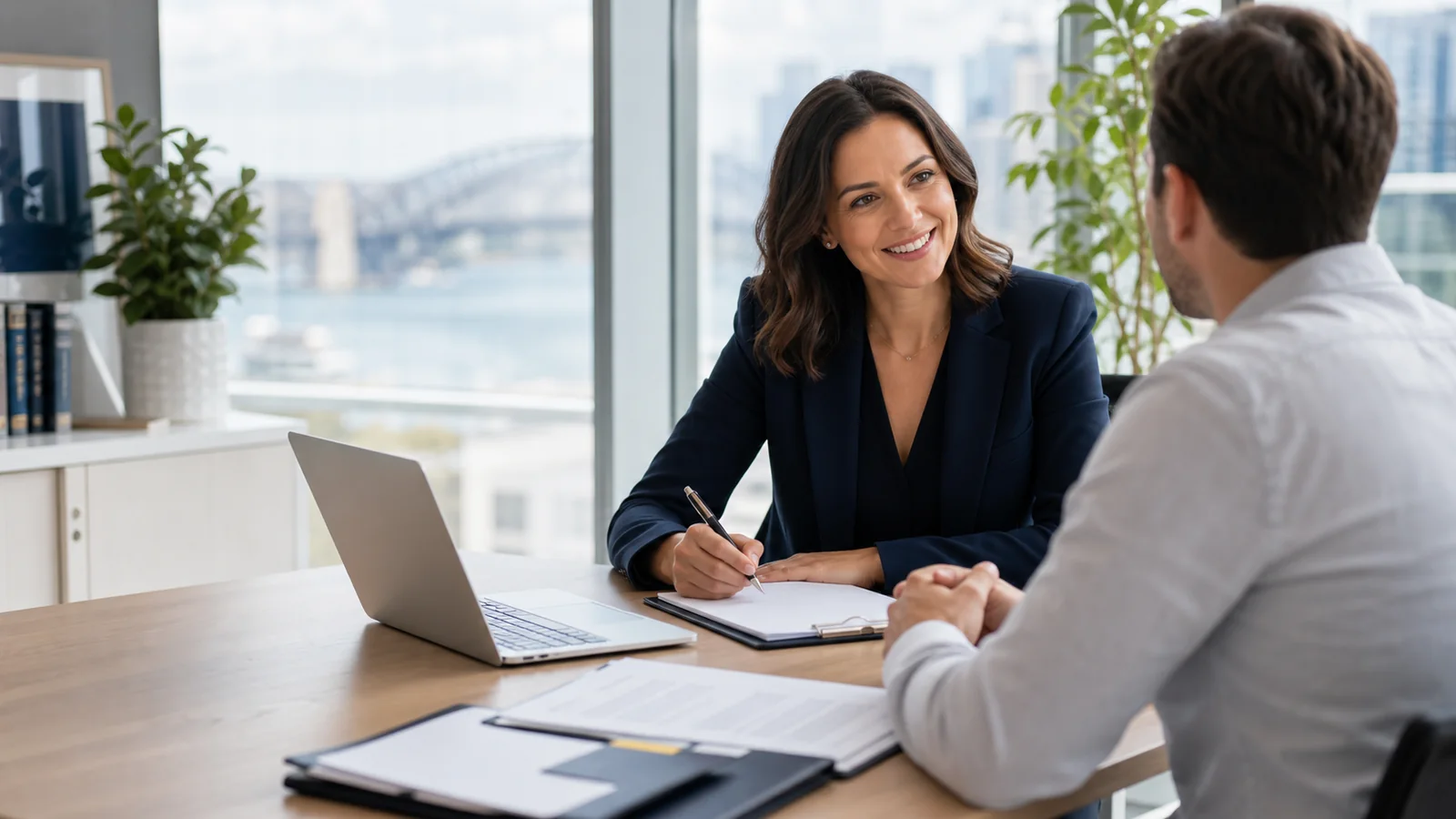 A TPD claims adviser reviewing claim documents with a client in a modern Sydney office.